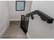 Beautiful stairwell with black handrail and light vinyl flooring at 340 1St N St # I, St Petersburg, FL 33701