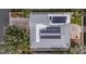 Bird's eye view displays solar panels on the roof of a house surrounded by lush greenery at 352 La Hacienda Dr, Indian Rocks Beach, FL 33785