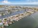 Wide aerial shot showcases waterfront homes with docks and boats on a clear, sunny day at 352 La Hacienda Dr, Indian Rocks Beach, FL 33785