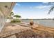Inviting backyard featuring waterfront views, a paver patio, and lush landscaping, ideal for relaxation at 352 La Hacienda Dr, Indian Rocks Beach, FL 33785