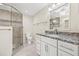 Bright bathroom featuring a marble countertop vanity and a glass-enclosed tiled shower with a mosaic accent at 352 La Hacienda Dr, Indian Rocks Beach, FL 33785
