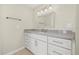 Bright bathroom features a granite countertop, white cabinetry, and stylish lighting fixture at 352 La Hacienda Dr, Indian Rocks Beach, FL 33785
