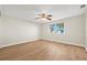 Bedroom with wood floors, a ceiling fan, and a large window providing natural light at 352 La Hacienda Dr, Indian Rocks Beach, FL 33785