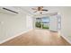 Bright bedroom with wood floors and a sliding glass door to the backyard and canal at 352 La Hacienda Dr, Indian Rocks Beach, FL 33785