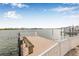 Wooden dock with a white fence and bench that provides access to the beautiful waterfront at 352 La Hacienda Dr, Indian Rocks Beach, FL 33785