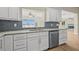 This kitchen features white cabinets, stainless steel appliances, and a beautiful view from the window at 352 La Hacienda Dr, Indian Rocks Beach, FL 33785