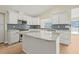 Bright kitchen featuring an island with granite countertops and stylish cabinetry at 352 La Hacienda Dr, Indian Rocks Beach, FL 33785