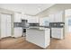 Beautiful kitchen with white cabinets, center island and stainless steel appliances at 352 La Hacienda Dr, Indian Rocks Beach, FL 33785