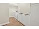 Laundry room with white cabinets, granite countertops, and a front load washer and dryer at 352 La Hacienda Dr, Indian Rocks Beach, FL 33785