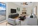 Living area features light wood floors, neutral walls, a fireplace and decor with water views at 352 La Hacienda Dr, Indian Rocks Beach, FL 33785