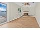 Bright room featuring light wood floors, neutral walls and a fireplace with a water view at 352 La Hacienda Dr, Indian Rocks Beach, FL 33785