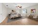 Stylized main bedroom features light wood floors, a ceiling fan, large windows and is well decorated at 352 La Hacienda Dr, Indian Rocks Beach, FL 33785
