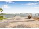 Paver patio with waterfront views and a fire pit, perfect for outdoor entertaining and relaxation at 352 La Hacienda Dr, Indian Rocks Beach, FL 33785