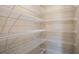 Large walk-in closet with multiple wire shelves providing ample storage space at 37147 Sagemoor Dr, Zephyrhills, FL 33541
