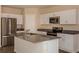 Bright kitchen with stainless steel appliances, center island and white cabinetry at 37147 Sagemoor Dr, Zephyrhills, FL 33541