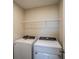 Laundry room featuring washer, dryer, and a wire shelf for storage at 37147 Sagemoor Dr, Zephyrhills, FL 33541