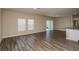 Spacious living room and open kitchen with stainless appliances and hardwood flooring at 37147 Sagemoor Dr, Zephyrhills, FL 33541