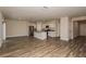 Open-concept living room and kitchen with stainless appliances and hardwood flooring at 37147 Sagemoor Dr, Zephyrhills, FL 33541