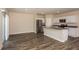 Open-concept living room and kitchen with stainless appliances and sliding doors at 37147 Sagemoor Dr, Zephyrhills, FL 33541