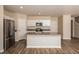 Open living room, kitchen with stainless appliances and hardwood flooring at 37147 Sagemoor Dr, Zephyrhills, FL 33541