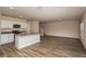 Bright living room and open kitchen with stainless appliances and hardwood flooring at 37147 Sagemoor Dr, Zephyrhills, FL 33541