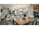 Open-concept living room with dining area and kitchen, featuring modern decor and natural light at 37206 Sagemoor Dr, Zephyrhills, FL 33541