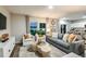Bright living room featuring modern decor, neutral colors, and comfortable seating arrangement at 37206 Sagemoor Dr, Zephyrhills, FL 33541