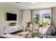 Cozy living room featuring a modern white media console, comfortable seating, and plenty of natural light at 37206 Sagemoor Dr, Zephyrhills, FL 33541