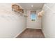 Well-organized walk-in closet featuring ample shelving and hanging space, and a view from the window at 37206 Sagemoor Dr, Zephyrhills, FL 33541