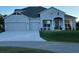 Charming single-story home with manicured lawn and a three-car garage, perfect curb appeal at 3895 Tate Ct, North Port, FL 34288