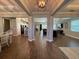 Open-concept living space with elegant wood-look tile flooring and high ceilings, great for entertaining at 3895 Tate Ct, North Port, FL 34288