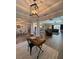 Expansive living area with a desk, modern lighting, and seamlessly flows into the kitchen and living spaces at 3895 Tate Ct, North Port, FL 34288