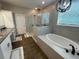 Luxurious bathroom features a soaking tub, a separate glass shower, and granite vanity at 3895 Tate Ct, North Port, FL 34288