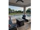 Outdoor patio with a fire pit, seating area, string lights, and pool views at 3895 Tate Ct, North Port, FL 34288