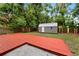 The backyard features a wooden deck and a small storage shed for tools and equipment at 3906 W Rogers Ave, Tampa, FL 33611
