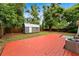 The backyard features a wooden deck and a small storage shed for tools and equipment at 3906 W Rogers Ave, Tampa, FL 33611