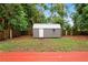 The backyard features a wooden deck and a small storage shed with metal roof for equipment at 3906 W Rogers Ave, Tampa, FL 33611