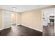 Bedroom features dark wood floors, neutral paint and a sliding door closet at 3906 W Rogers Ave, Tampa, FL 33611