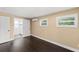 Bedroom features dark wood floors, white trim and a door to the bathroom at 3906 W Rogers Ave, Tampa, FL 33611