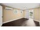 Bedroom features dark wood floors, white trim, and a mini split air conditioning unit at 3906 W Rogers Ave, Tampa, FL 33611
