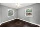 This bedroom features dark wood floors, ceiling fan and bright windows at 3906 W Rogers Ave, Tampa, FL 33611