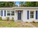 Close-up of front door with blue shutters, clean stucco, and an inviting entrance at 3906 W Rogers Ave, Tampa, FL 33611