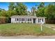 Charming single-story home with blue shutters and a well-maintained front yard and classic white mailbox at 3906 W Rogers Ave, Tampa, FL 33611