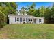 Lovely single-story home with well-kept lawn and blue shutters adding a touch of style and curb appeal at 3906 W Rogers Ave, Tampa, FL 33611