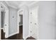 Hallway with hardwood floors and neutral paint provides access to various rooms at 3906 W Rogers Ave, Tampa, FL 33611