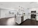Bright kitchen features stainless appliances, marble countertops, a kitchen island, and dark wood floors at 3906 W Rogers Ave, Tampa, FL 33611