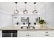 Kitchen island features marble countertops, modern lighting, stainless dishwasher and sink at 3906 W Rogers Ave, Tampa, FL 33611
