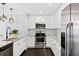 Modern kitchen featuring white cabinets, granite countertops, and stainless steel appliances at 3906 W Rogers Ave, Tampa, FL 33611