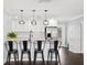 Modern kitchen featuring a large island, pendant lighting, white cabinets, and stainless steel appliances at 3906 W Rogers Ave, Tampa, FL 33611