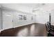 Bright living area with large windows, dark hardwood floors, and a welcoming atmosphere at 3906 W Rogers Ave, Tampa, FL 33611